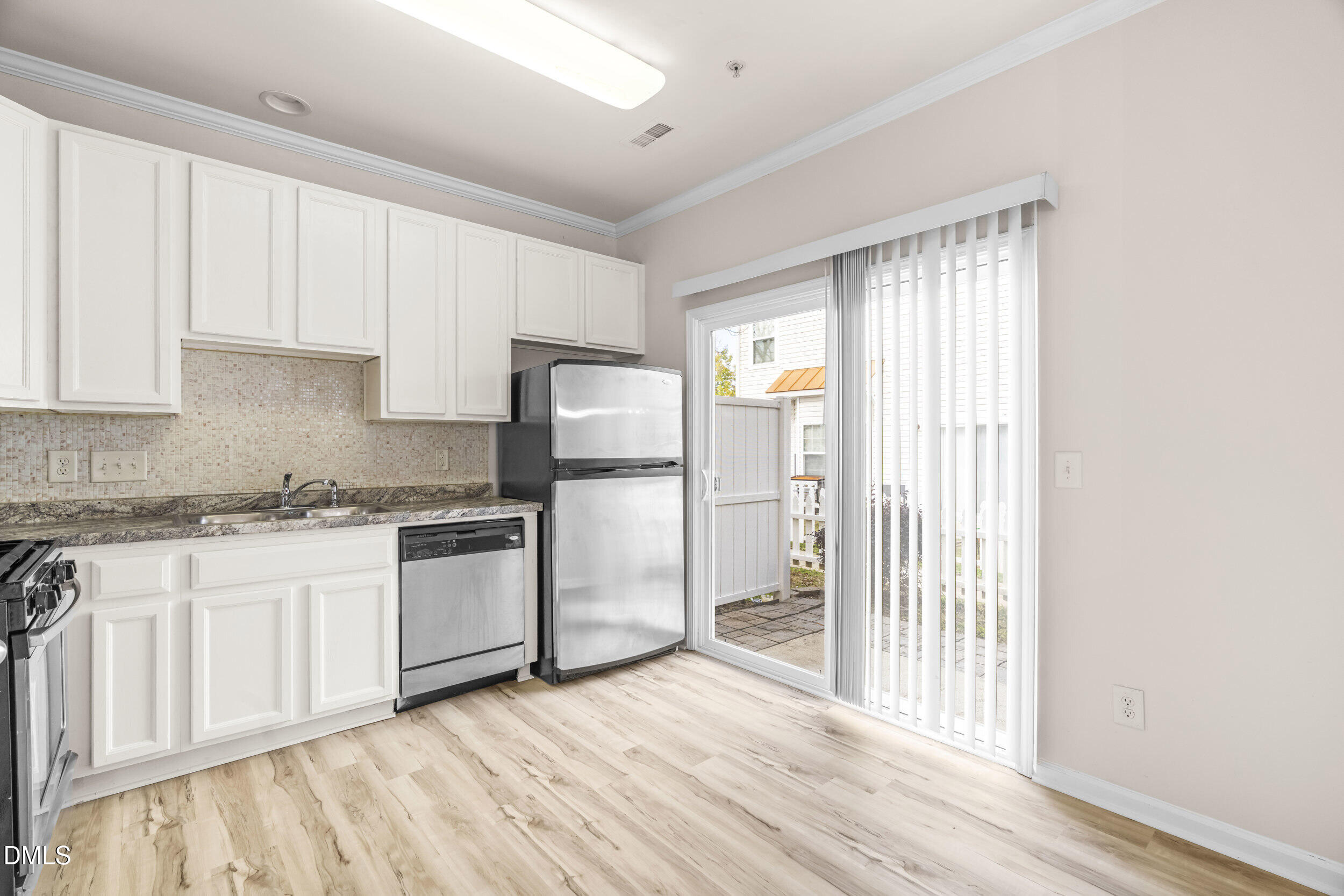 11710 Coppergate Drive, Unit 111 Raleigh, NC 27614 - Photo 6 of 31 a kitchen with a refrigerator sink and cabinets