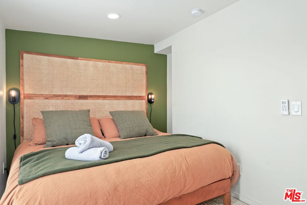 6763 Sunset Road Joshua Tree, CA 92252 - Photo 14 of 31 a bedroom with a bed and a potted plant