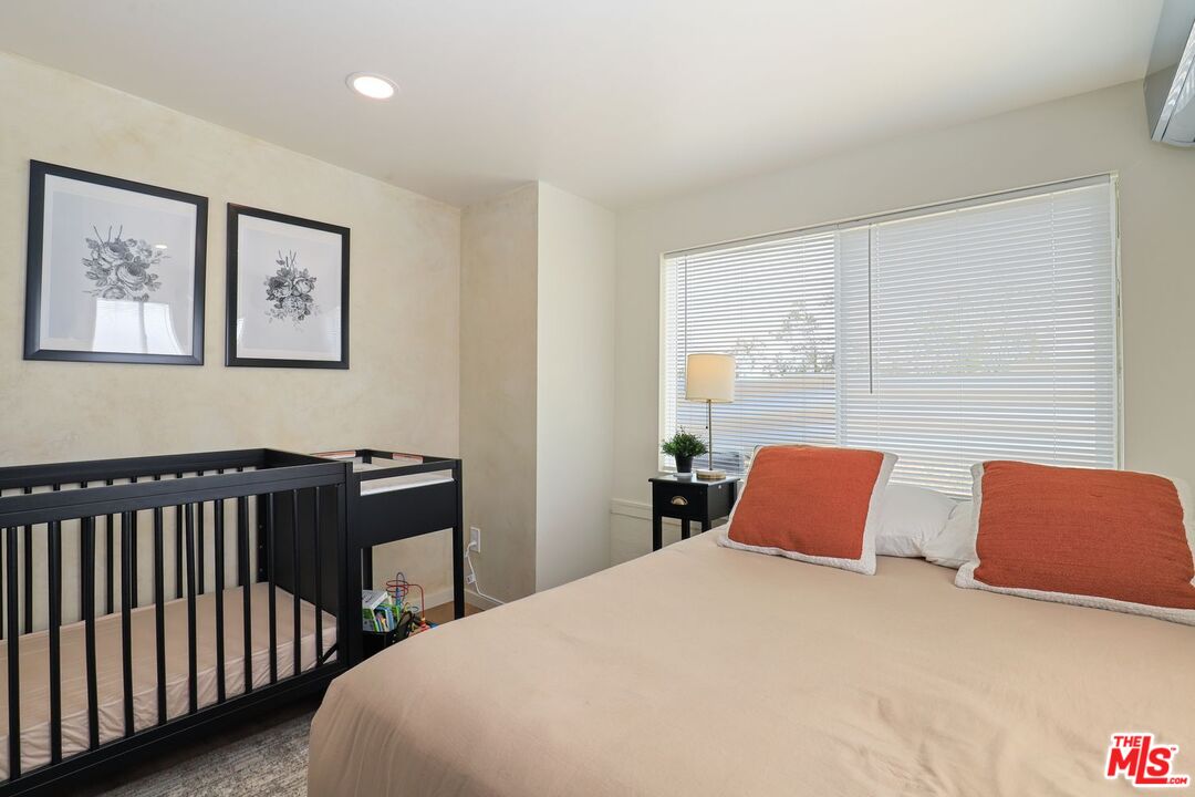 6763 Sunset Road Joshua Tree, CA 92252 - Photo 15 of 31 a bedroom with a bed and wooden floor