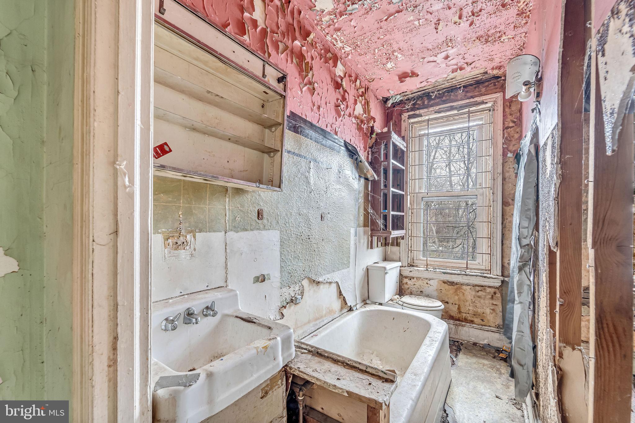 839 Spruce Street Camden, NJ 08103 - Photo 9 of 15 a bathroom with a tub sink and mirror