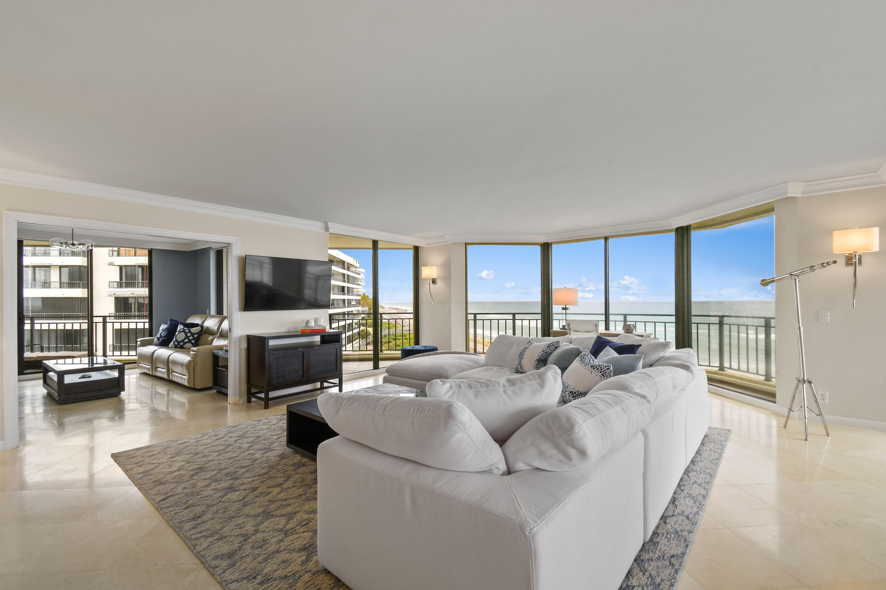 19850 South Beach Road, Unit 5A Jupiter, FL 33469 - Photo 18 of 78 a living room with furniture flat screen tv and a large window