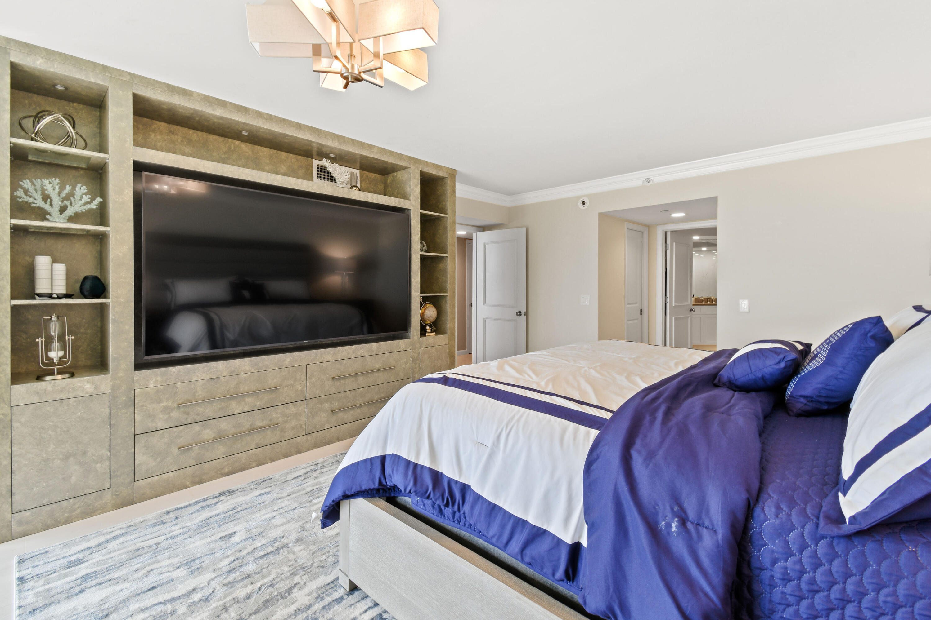 19850 South Beach Road, Unit 5A Jupiter, FL 33469 - Photo 38 of 78 a bedroom with a bed and a flat screen tv