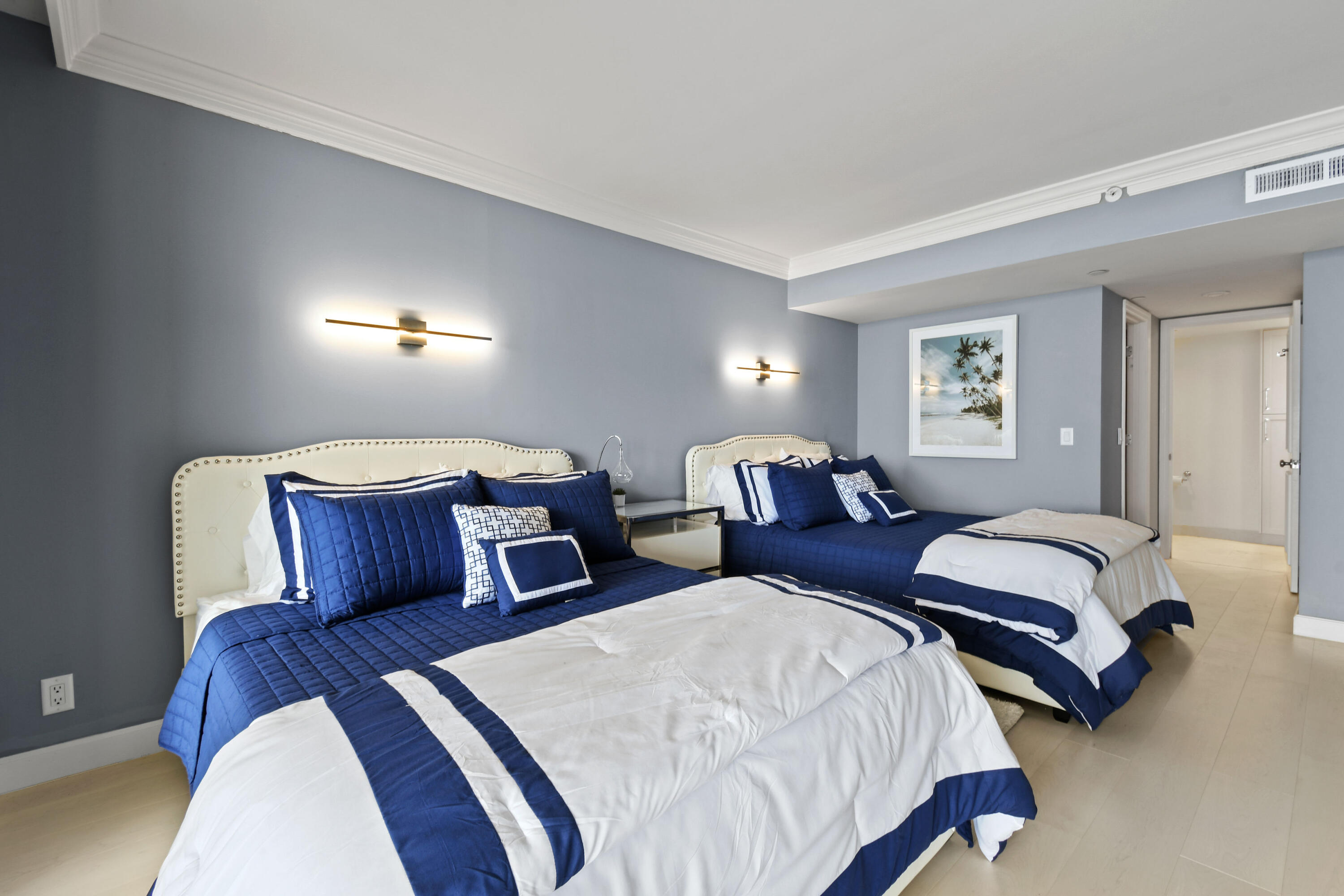 19850 South Beach Road, Unit 5A Jupiter, FL 33469 - Photo 47 of 78 a bedroom with two beds and painting on the wall