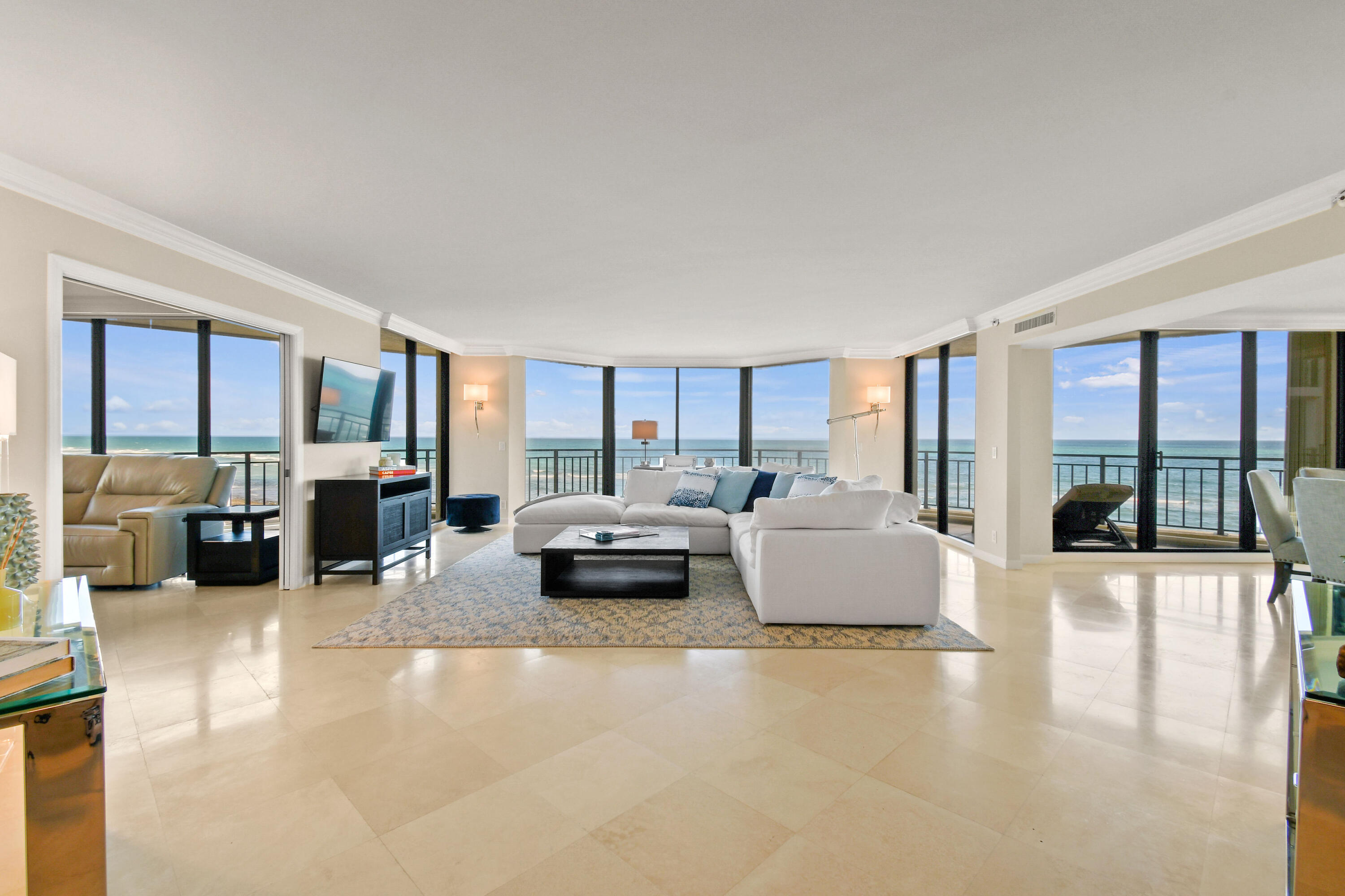 19850 South Beach Road, Unit 5A Jupiter, FL 33469 - Photo 8 of 78 a living room with furniture large window and glass table