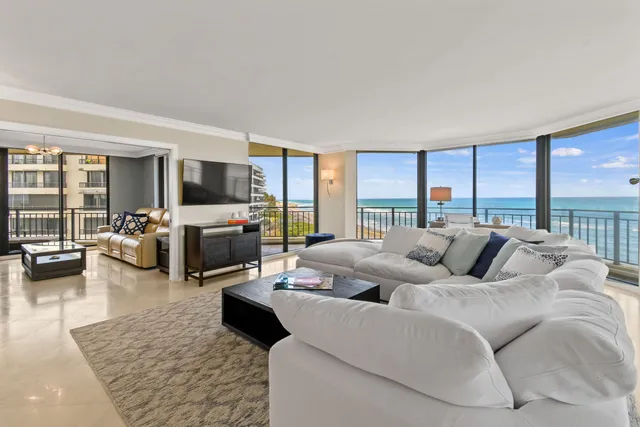 a living room with furniture large window and flat screen tv