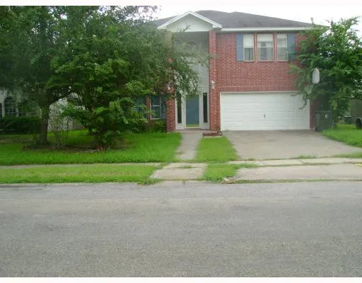 a front view of a house with a yard and a garage