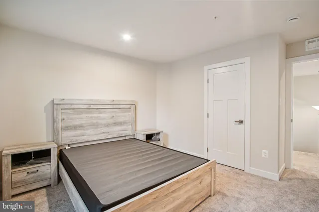 a spacious bedroom with a bed and large window