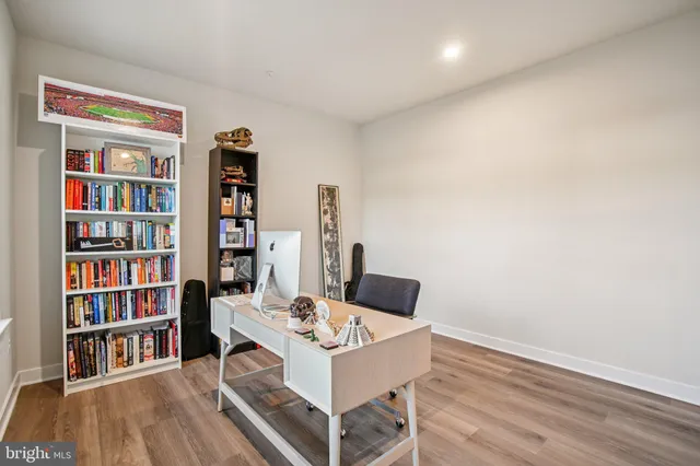 a living room with furniture and a book shelf