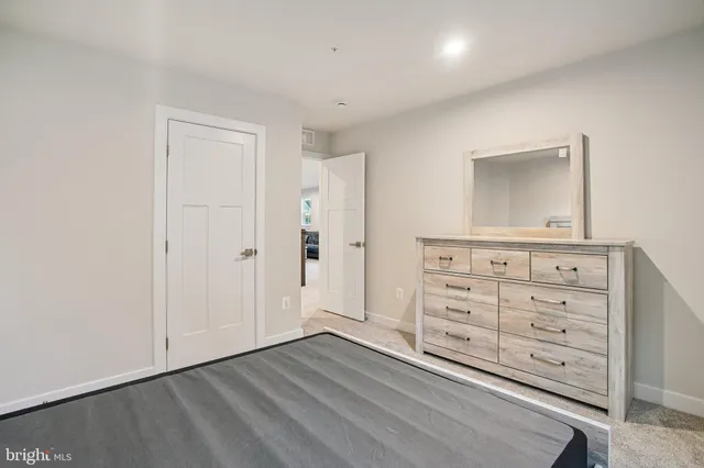 a bedroom with a bed and a dresser