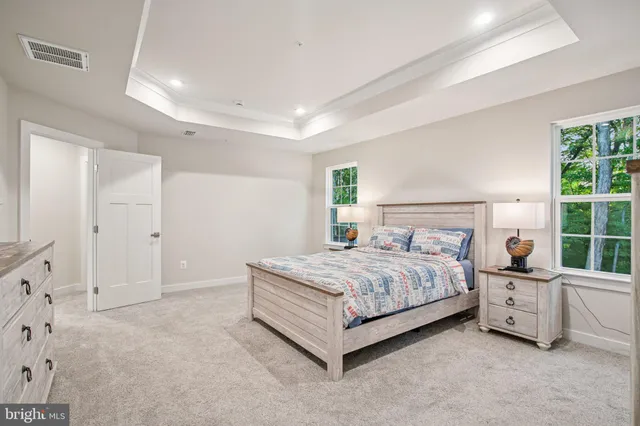 a bathroom with a tub a sink and mirror
