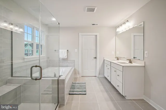 a bathroom with a sink a toilet a mirror and shower curtain