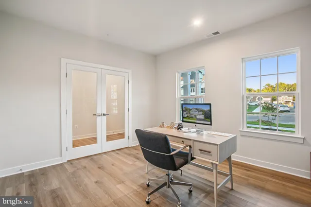a workspace with wooden floor and a window