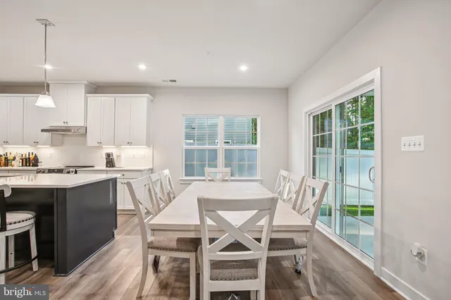 a large kitchen with a table and chairs