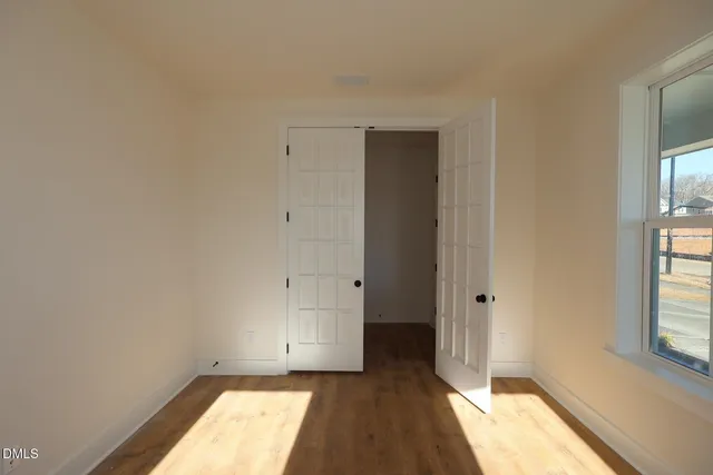 a living room with stainless steel appliances kitchen island a stove a refrigerator a sink and a cabinets