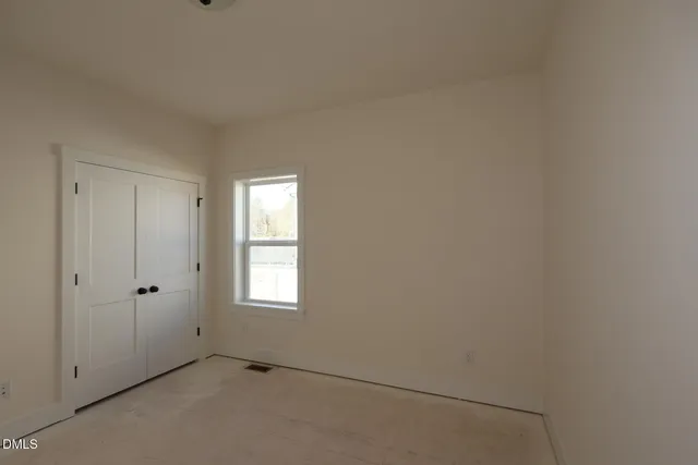 a view of a livingroom with a ceiling fan and window