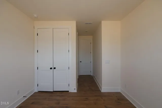 a big room with closet and windows