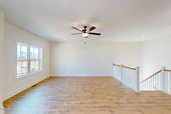 a bathroom with a shower a toilet and a window