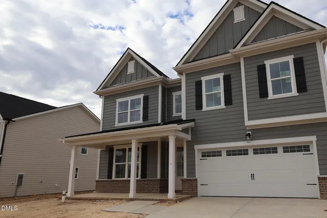a view of a house with wooden fence