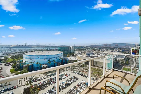 a view of a balcony with wooden floor and city view
