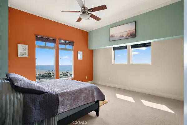 a spacious bedroom with a bed and a dresser