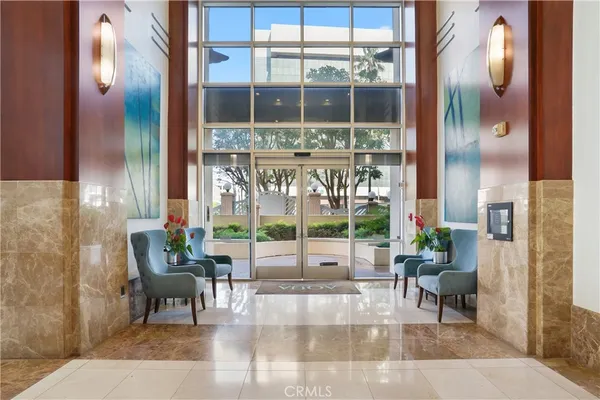 a living room filled with furniture and a large window