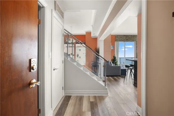 a view of entryway and hall with wooden floor