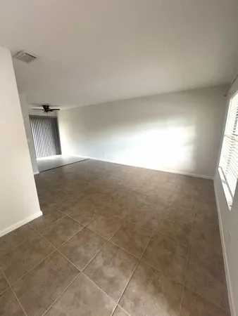 an empty room with windows and entrance