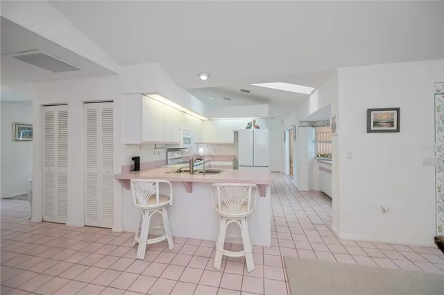 a spacious bedroom with a bed and a table in it