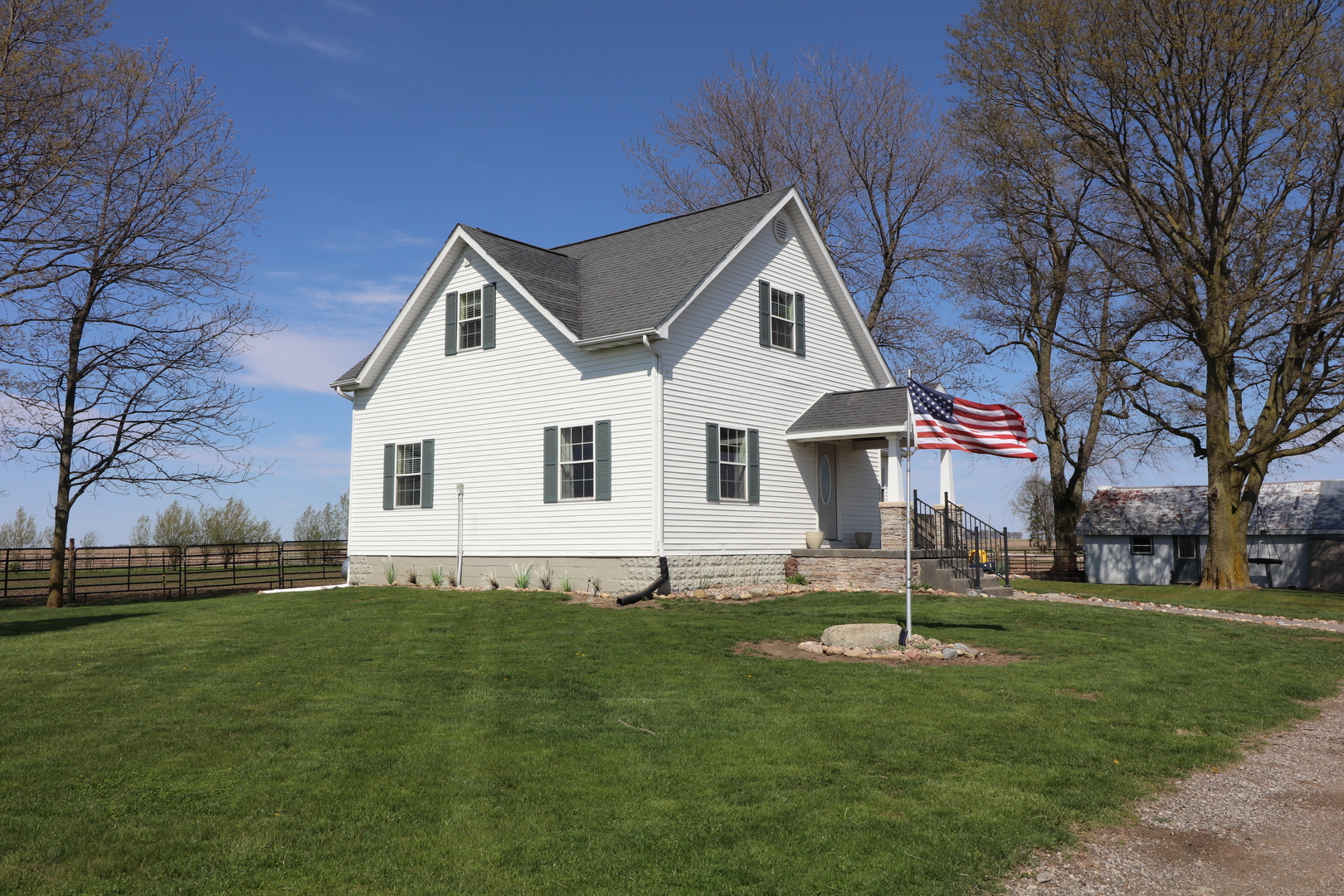 a front view of house with yard and green space