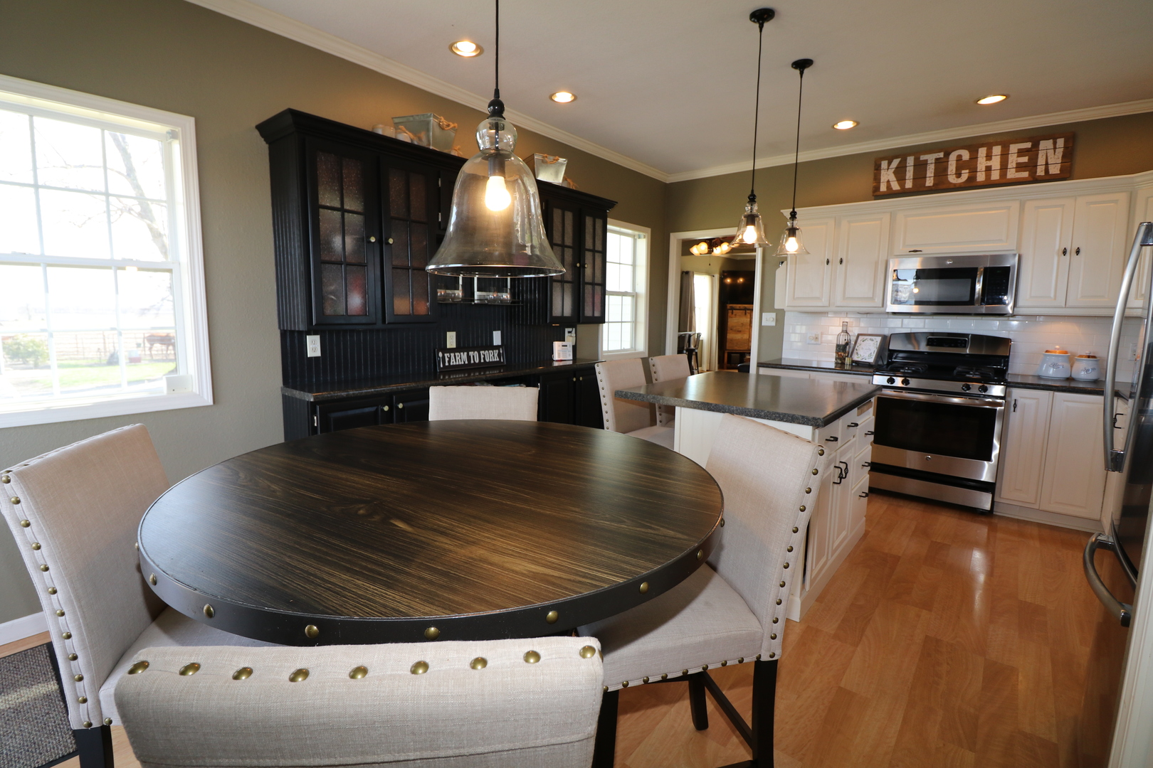 10942 Meridian Road Beason, IL 62512 - Photo 11 of 21 a large kitchen with stainless steel appliances granite countertop a stove a sink a microwave a island and chairs