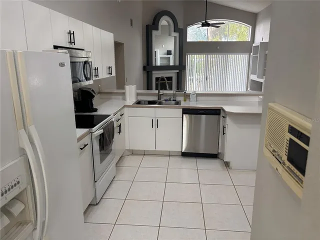 a kitchen with stainless steel appliances granite countertop a refrigerator a stove a sink and dishwasher