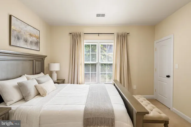 a bedroom with a large bed and a large window