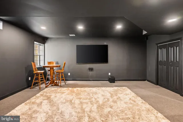 a bedroom with furniture and a flat screen tv