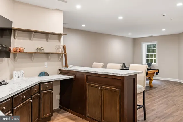 a kitchen with a sink a counter space appliances and cabinets
