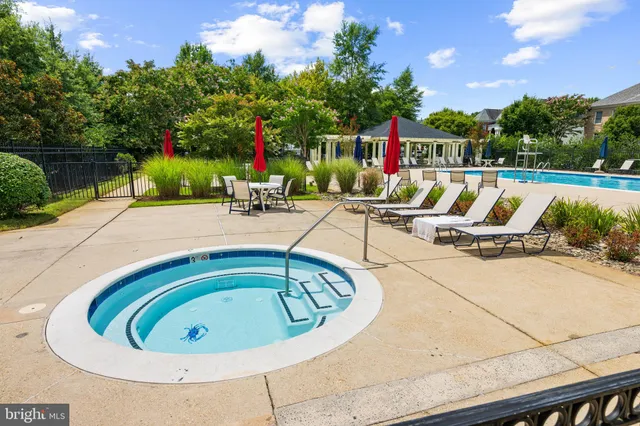 a swimming pool with outdoor seating and yard