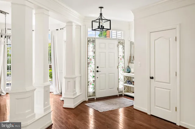 a view of a hallway with wooden floor and entryway