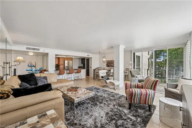 a living room with fireplace furniture and a large window