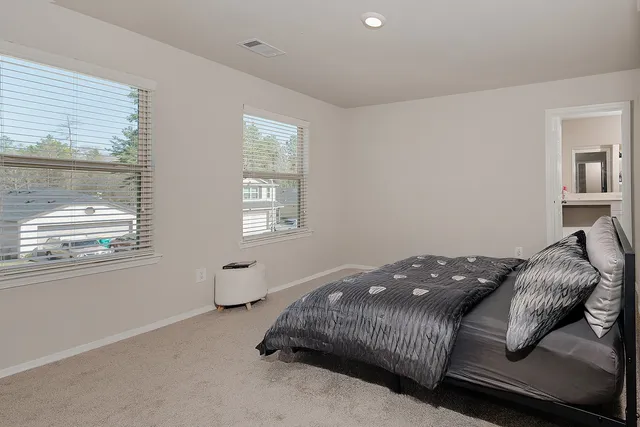 a bedroom with a bed and window