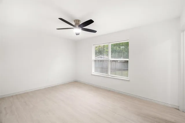 a view of an empty room with glass door and garden