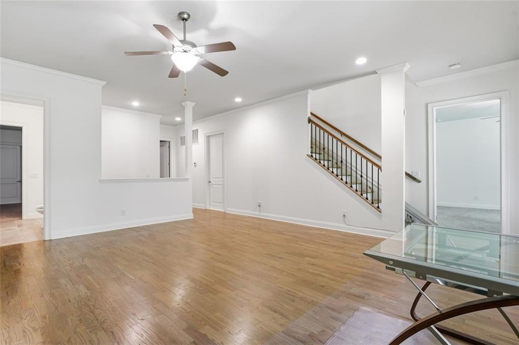337 Rosshandler Road Suwanee, GA 30024 - Photo 29 of 45 a view of an empty room with wooden floor and a ceiling fan