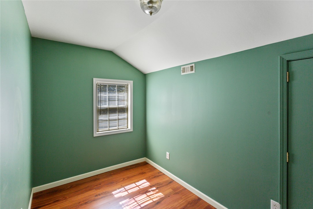 621 Burns Mill Road West Union, SC 29696 - Photo 19 of 45 Bright hardwood floors and a sloped ceiling create a cozy and inviting bedroom space.