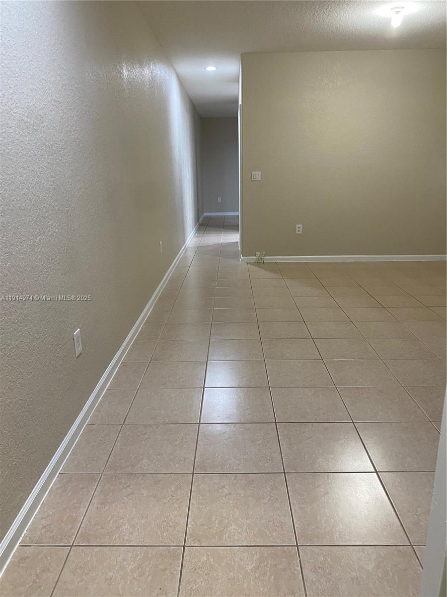 8395 Southwest 29th Street, Unit 102 Miramar, FL 33025 - Photo 11 of 20 a view of a livingroom with an empty space and a window