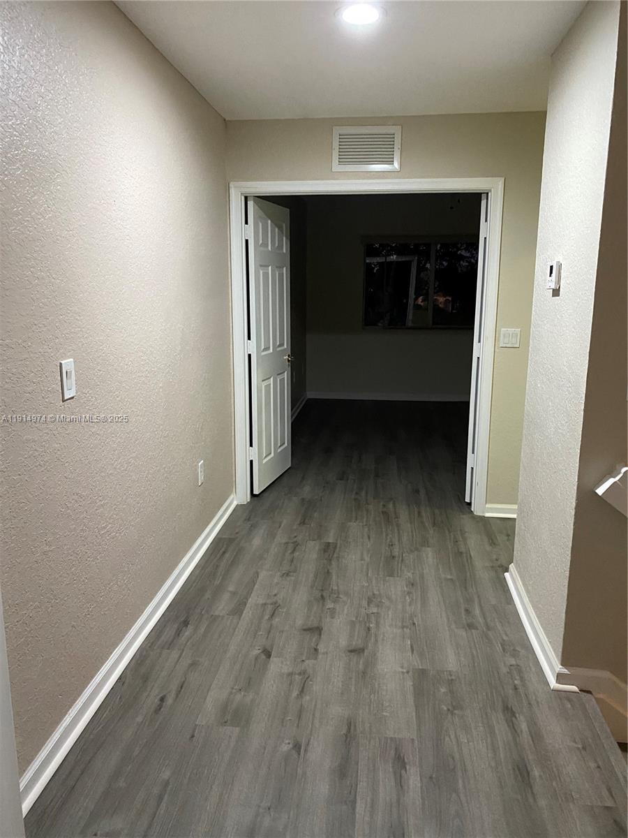 8395 Southwest 29th Street, Unit 102 Miramar, FL 33025 - Photo 18 of 20 wooden floor in an empty room