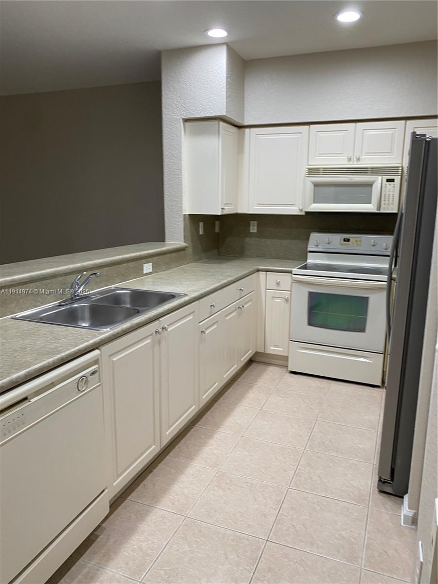 8395 Southwest 29th Street, Unit 102 Miramar, FL 33025 - Photo 7 of 20 a kitchen with a sink and cabinets