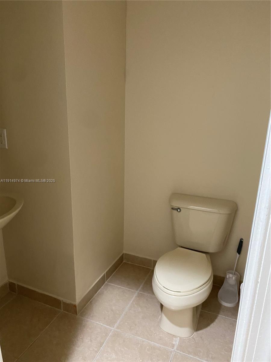 8395 Southwest 29th Street, Unit 102 Miramar, FL 33025 - Photo 8 of 20 a white toilet sitting next to a white wall
