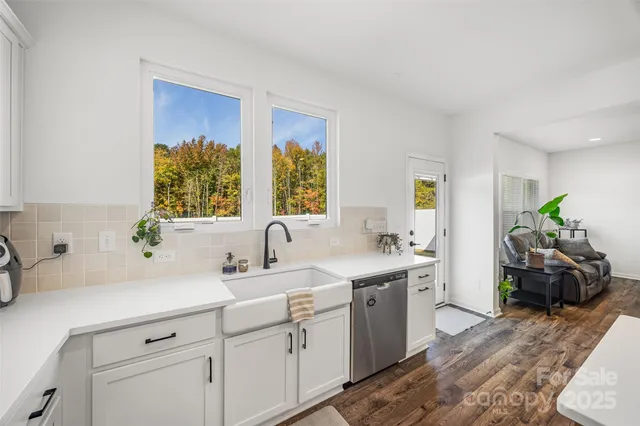a kitchen with a sink cabinets and wooden floor
