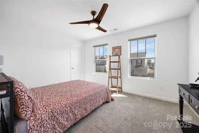 a bedroom with a large bed and a window