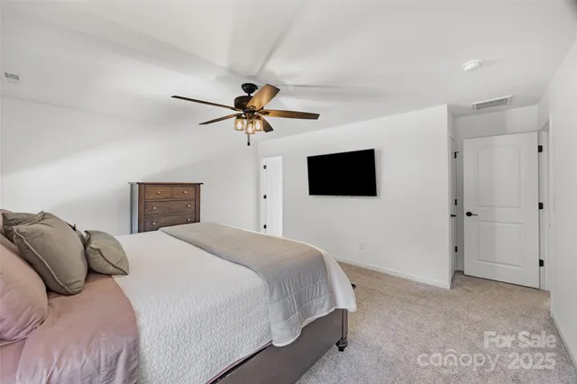 a bedroom with a bed and a tv