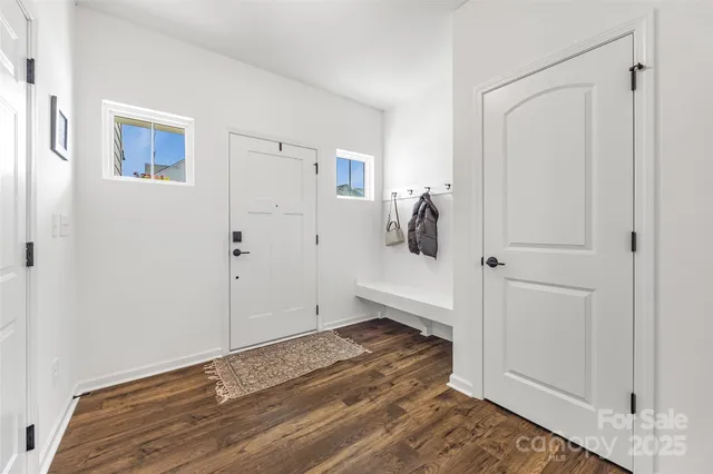 a view of a room with wooden floor and a bathroom