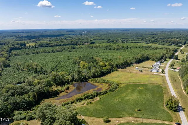 a view of a big yard with table and chairs
